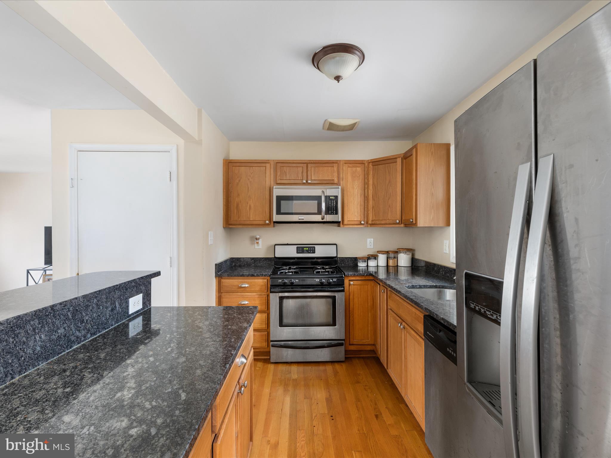 4002 Ronson Drive Alexandria, VA 22310 - Photo 7 of 30 a kitchen with stainless steel appliances granite countertop a refrigerator a stove top oven a sink and dishwasher