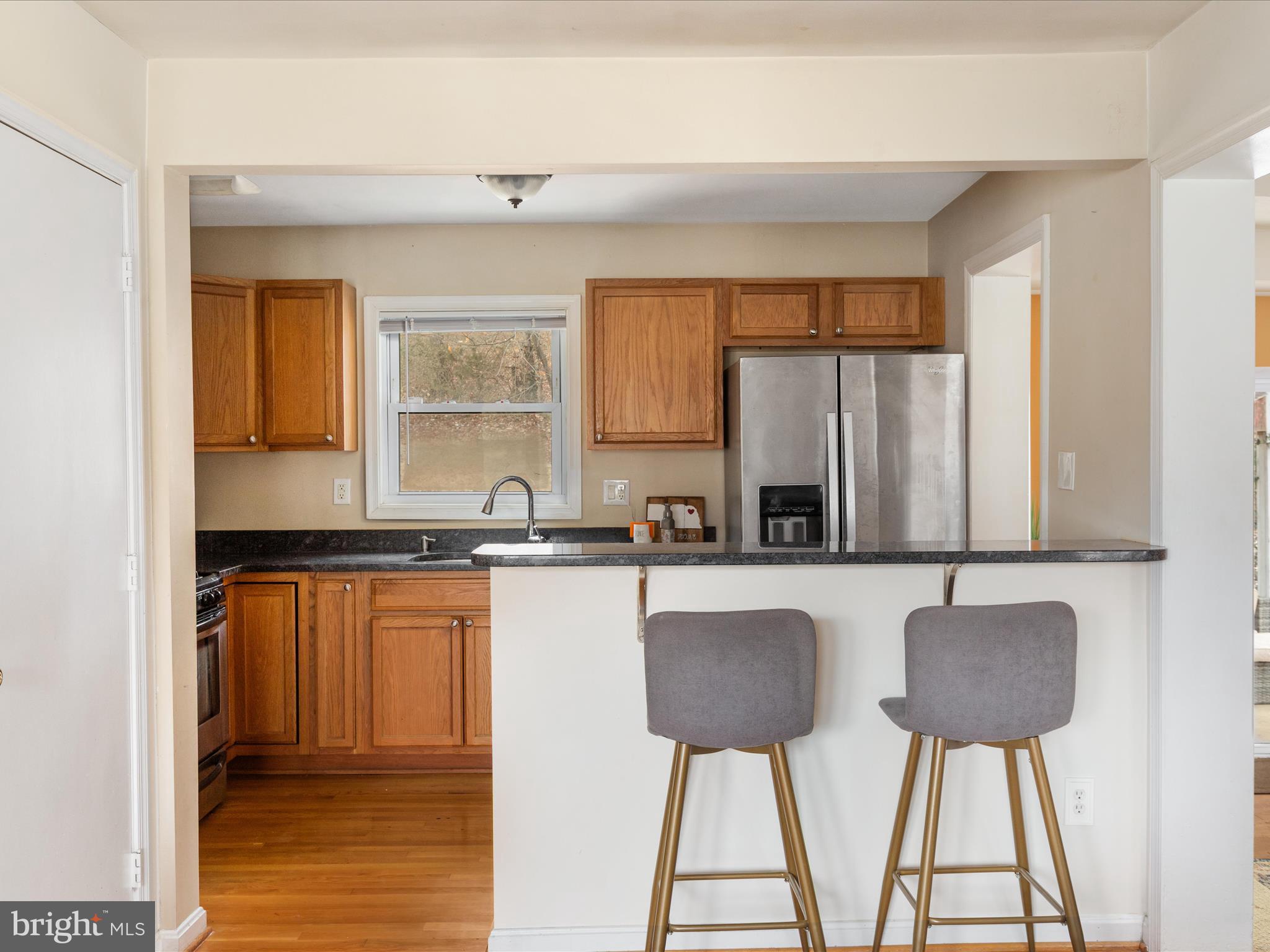 4002 Ronson Drive Alexandria, VA 22310 - Photo 8 of 30 a kitchen with stainless steel appliances granite countertop a stove a sink and a microwave