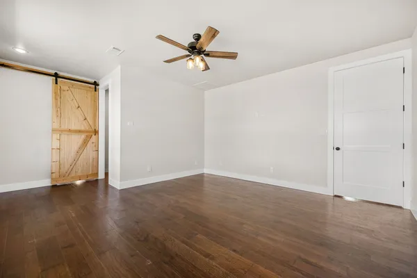 a kitchen with a sink and wooden floor