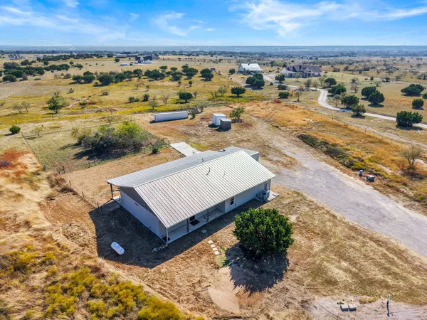 an aerial view of a house with a ocean view