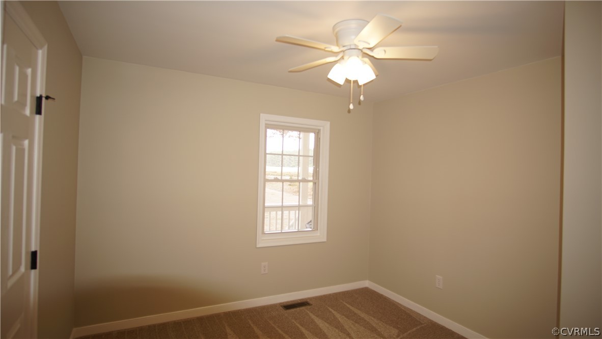 8111 Holdsworth Road Disputanta, VA 23842 - Photo 30 of 37 an empty room with windows and fan