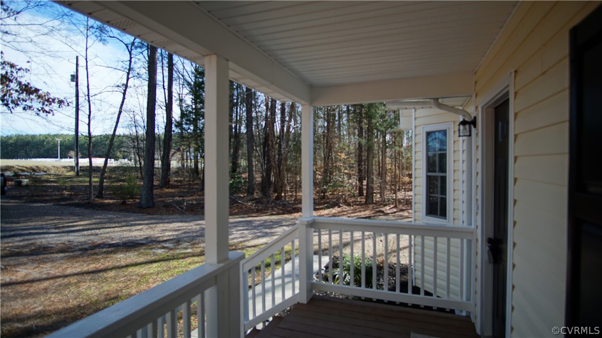 8111 Holdsworth Road Disputanta, VA 23842 - Photo 35 of 37 a view of a porch with a floor to ceiling window and wooden fence