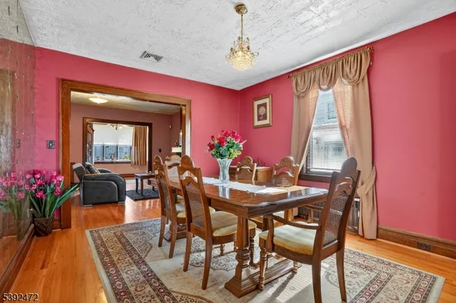 a view of a dining room with furniture and a potted plant