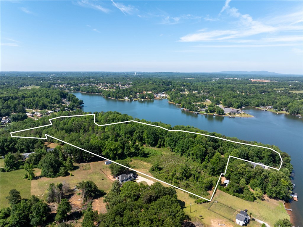 0 Ben Hurt Road Lyman, SC 29365 - Photo 1 of 21 A sweeping aerial view showcases a waterfront property with lush tree cover and direct lake access.