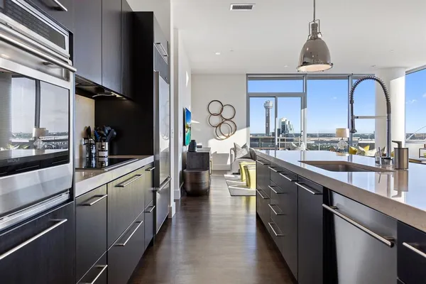 a kitchen with stainless steel appliances a sink stove and cabinets