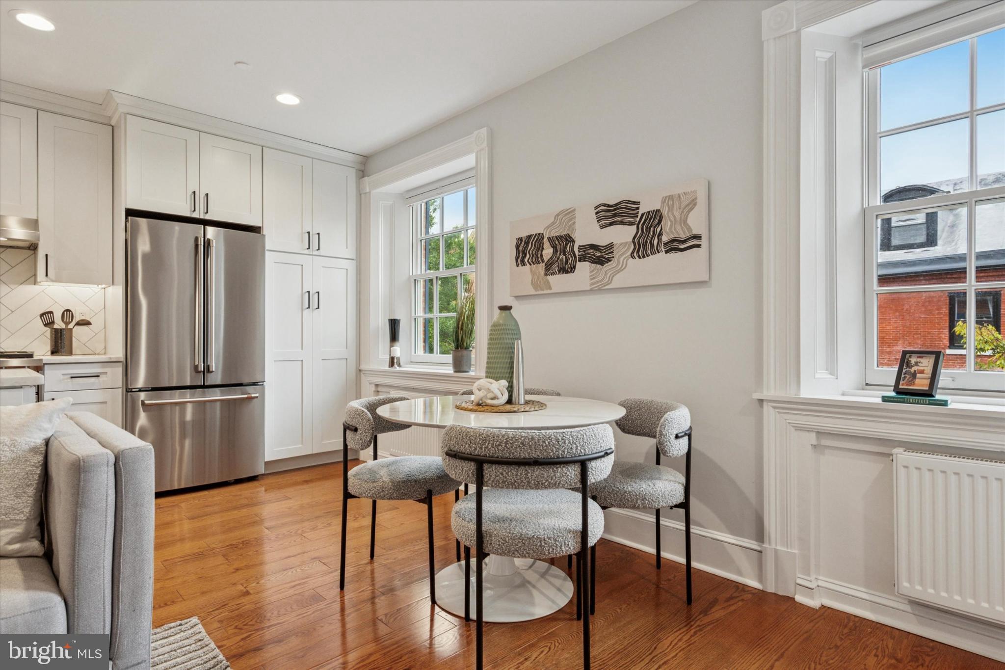 1215 Spruce Street, Unit 301 Philadelphia, PA 19107 - Photo 11 of 27 a kitchen with stainless steel appliances a dining table chairs refrigerator and sink