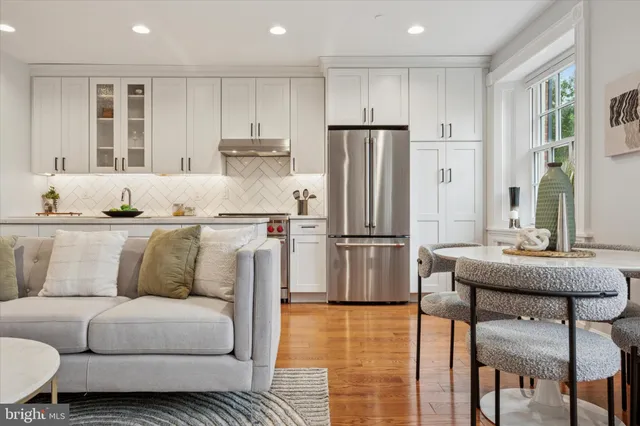 a kitchen with stainless steel appliances granite countertop a refrigerator and a stove top oven