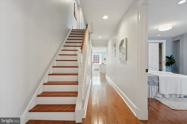 a view of entryway and hall with wooden floor