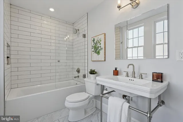 a bathroom with a sink toilet tub and shower