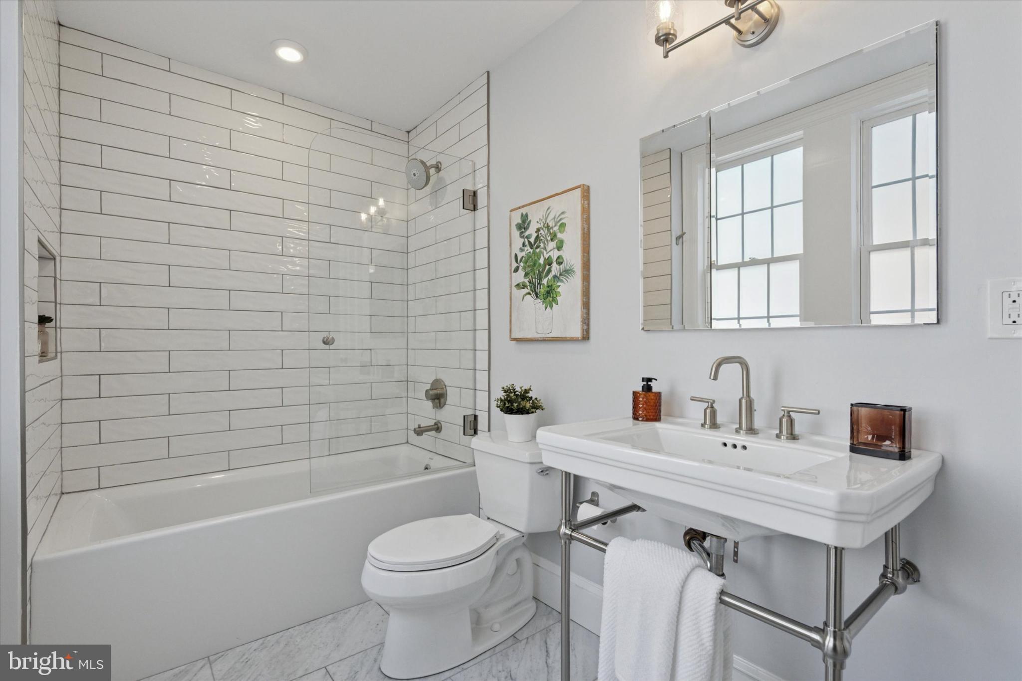 1215 Spruce Street, Unit 301 Philadelphia, PA 19107 - Photo 19 of 27 a bathroom with a sink toilet tub and shower