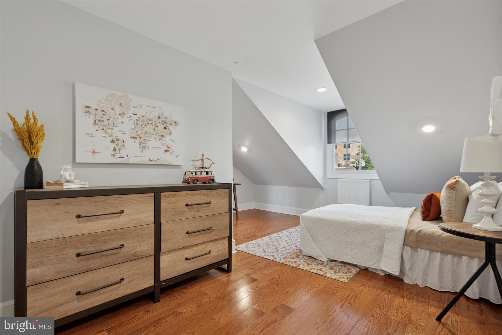 1215 Spruce Street, Unit 301 Philadelphia, PA 19107 - Photo 20 of 27 a bedroom with a bed and wooden floor