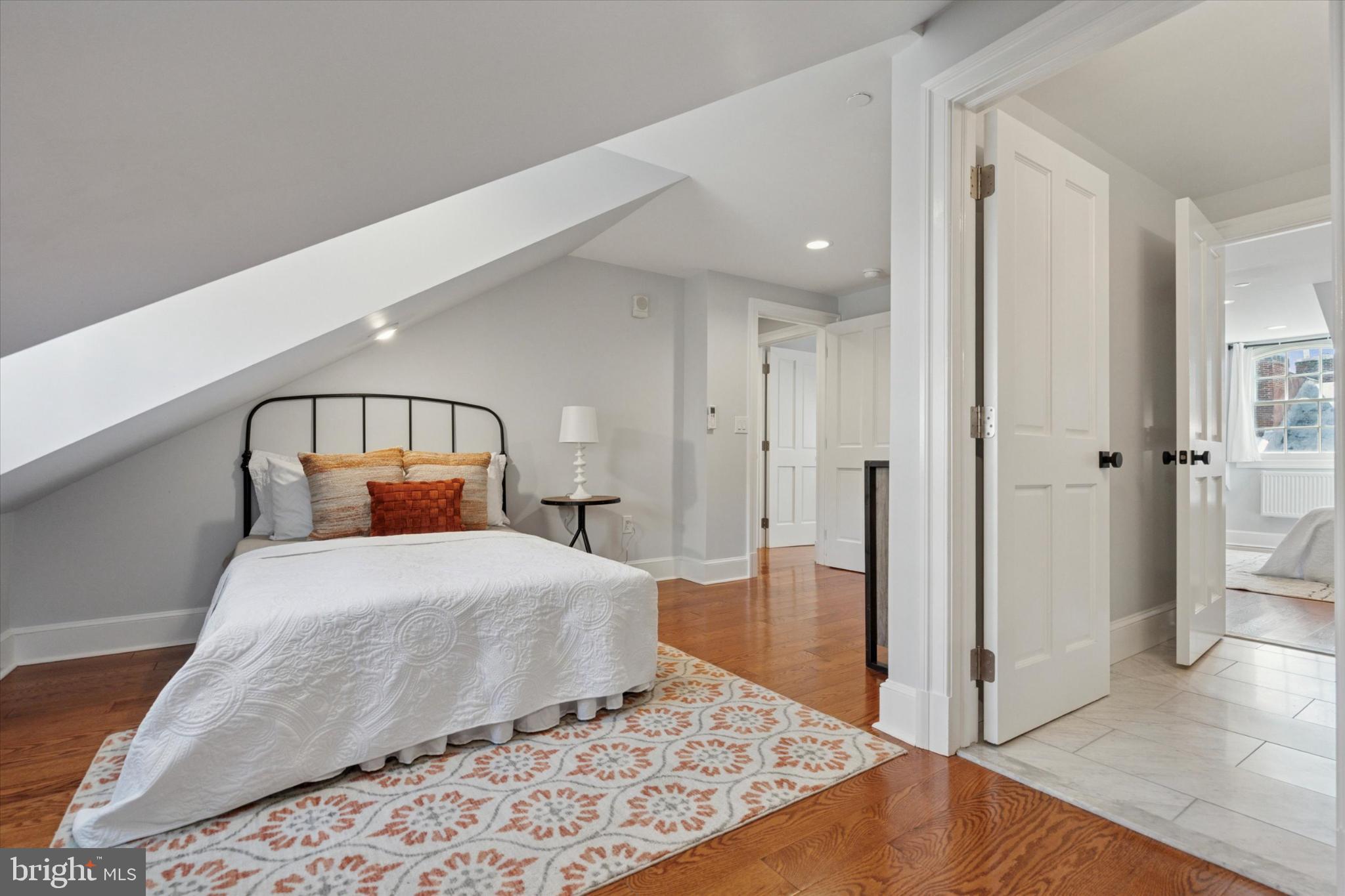 1215 Spruce Street, Unit 301 Philadelphia, PA 19107 - Photo 21 of 27 a bedroom with a bed and a mirror