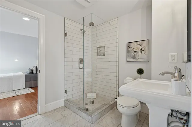 a bathroom with a sink toilet and shower