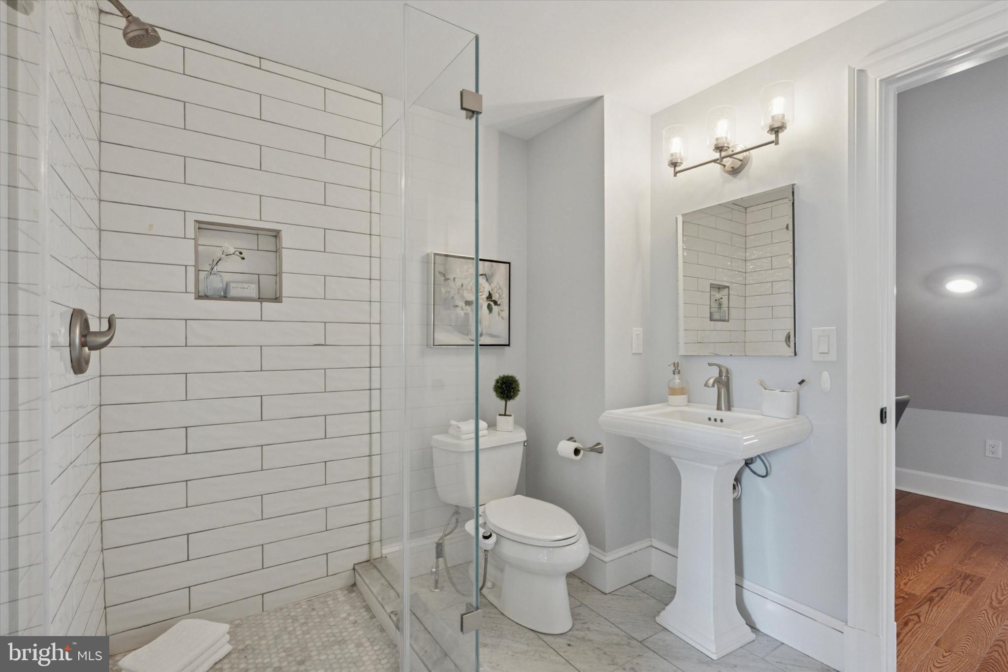 1215 Spruce Street, Unit 301 Philadelphia, PA 19107 - Photo 23 of 27 a bathroom with a toilet sink and shower