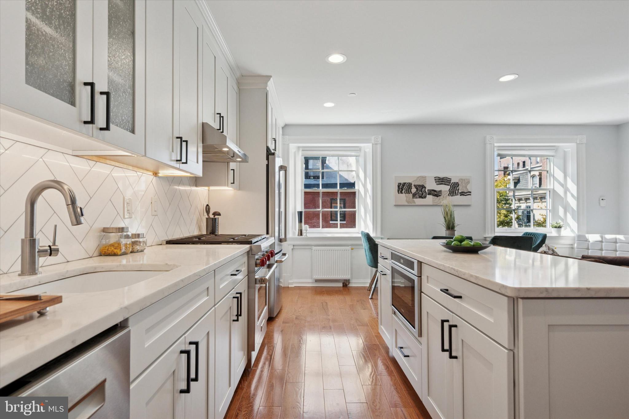 1215 Spruce Street, Unit 301 Philadelphia, PA 19107 - Photo 5 of 27 a kitchen with a sink stove and cabinets