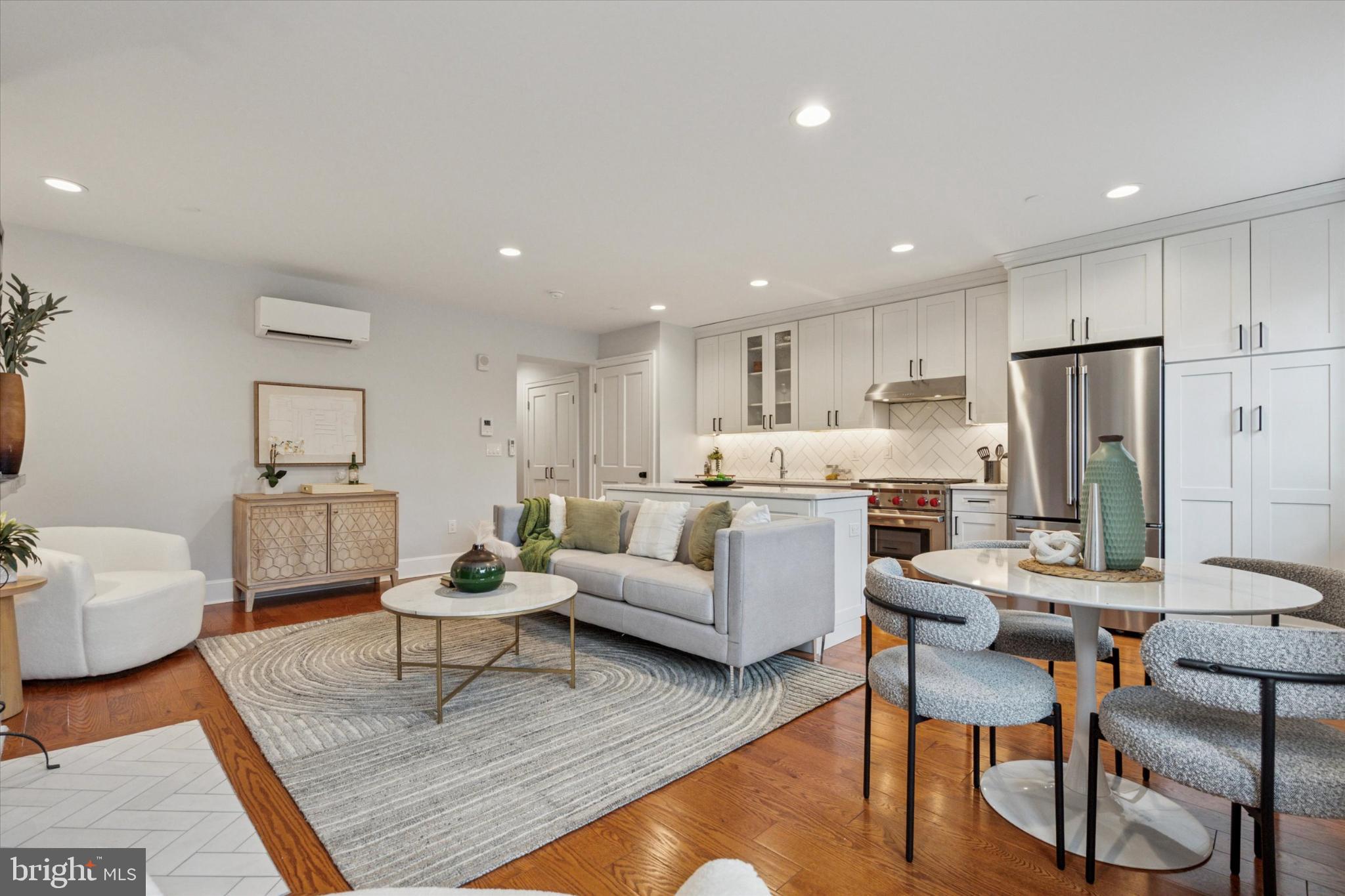 1215 Spruce Street, Unit 301 Philadelphia, PA 19107 - Photo 7 of 27 a living room with furniture and kitchen view