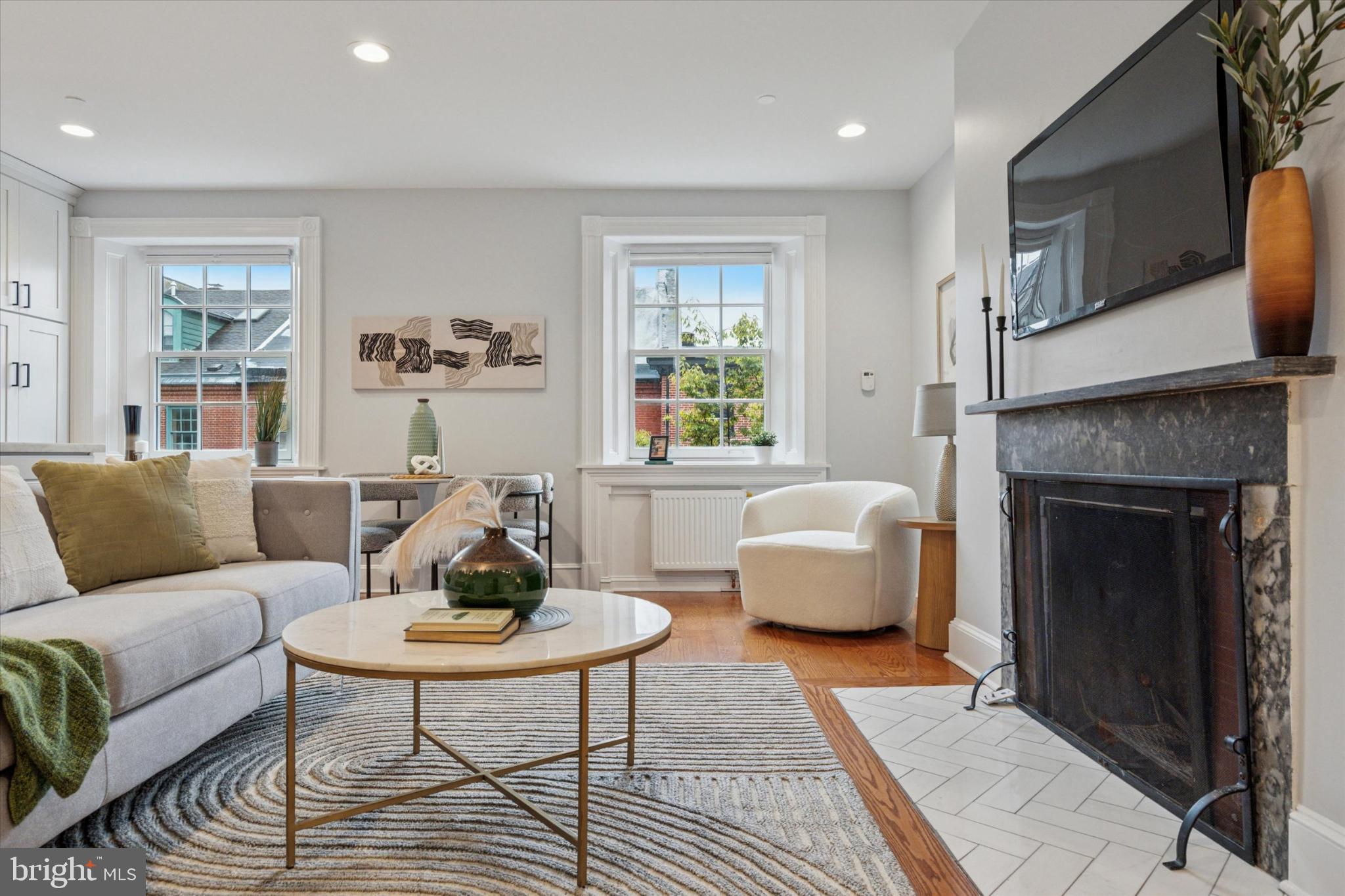 1215 Spruce Street, Unit 301 Philadelphia, PA 19107 - Photo 9 of 27 a living room with furniture and a fireplace