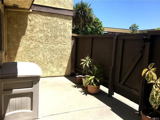 a view of a porch with furniture and a potted plant