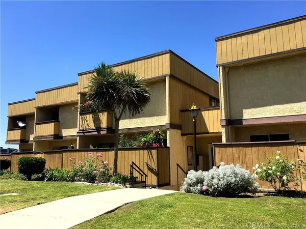 a view of a house with backyard porch and sitting area