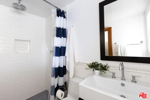 a view of a pathway along with potted plants