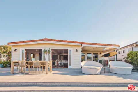 a view of a patio with table and chairs