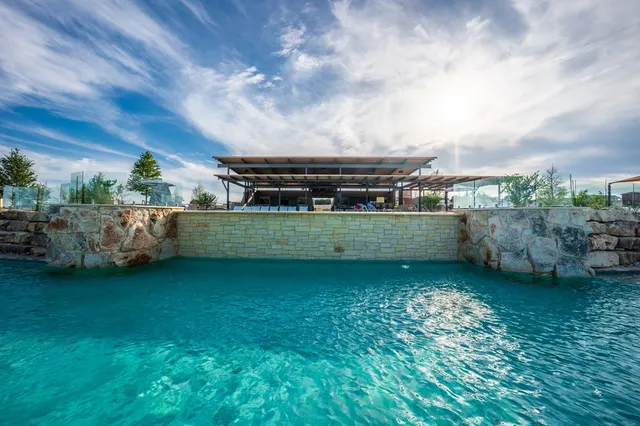 a view of a playground with a house in the background