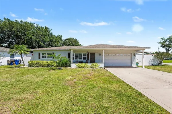 a front view of house with yard and green space