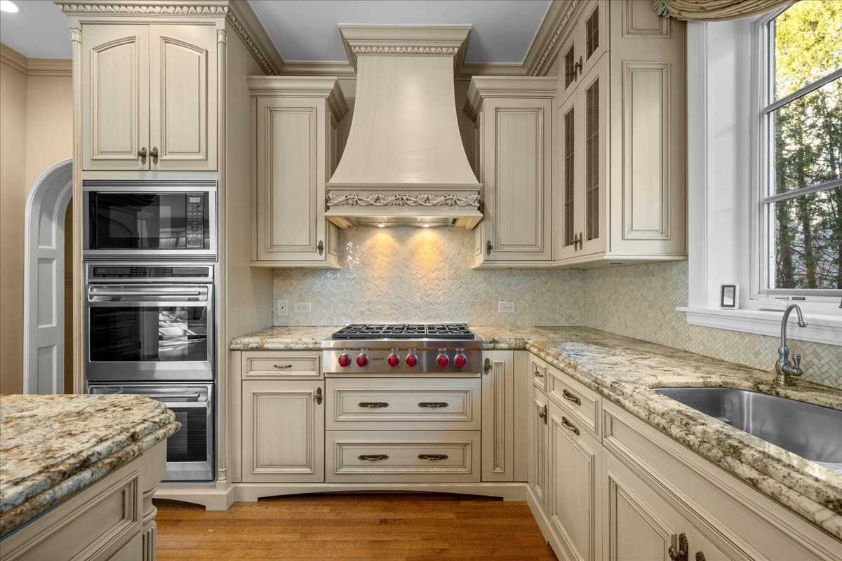 123 Oxford Road Kenilworth, IL 60043 - Photo 27 of 60 a kitchen with granite countertop a stove and a sink