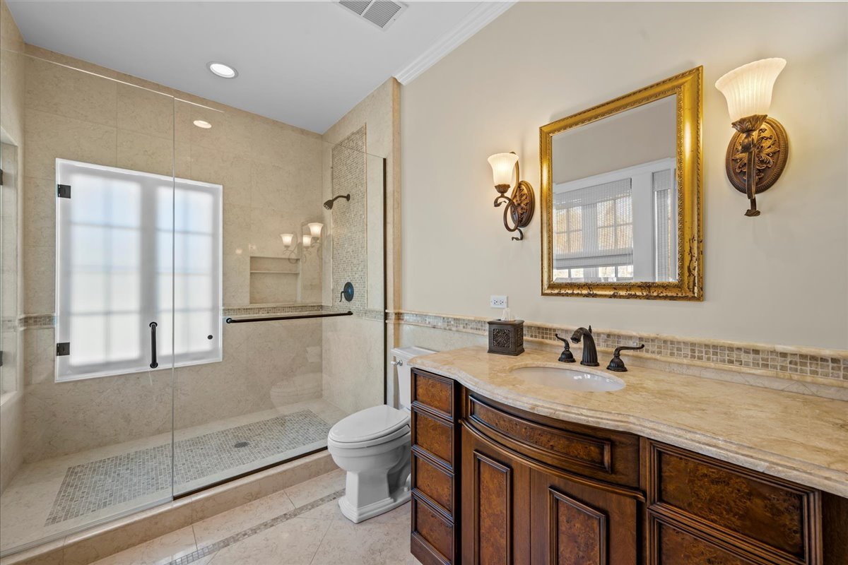 123 Oxford Road Kenilworth, IL 60043 - Photo 44 of 60 a bathroom with a toilet a sink and mirror