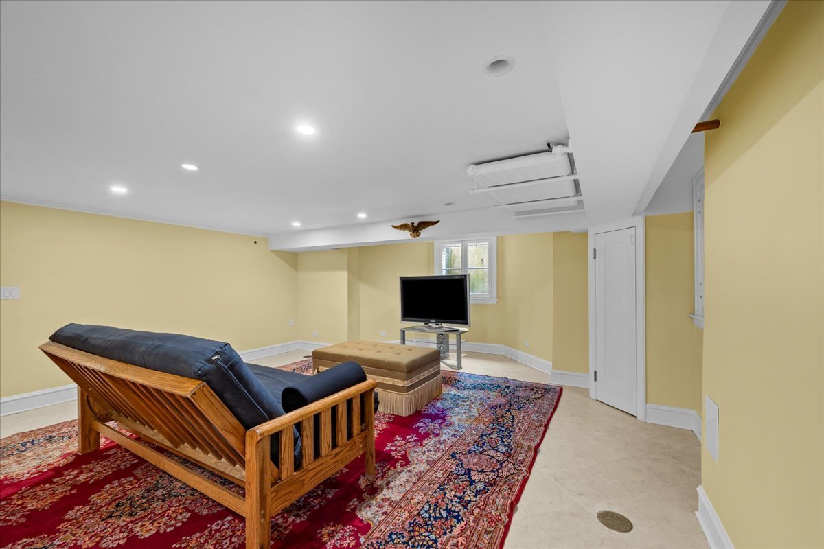 123 Oxford Road Kenilworth, IL 60043 - Photo 52 of 60 a living room with furniture and a flat screen tv