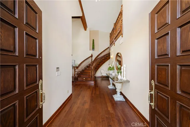 a view of entryway and hall with wooden floor