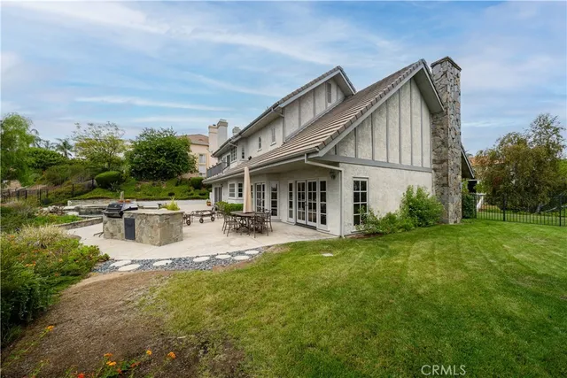 a front view of a house with swimming garden and patio