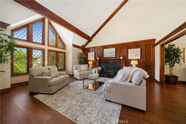 a living room with fireplace furniture and a large window