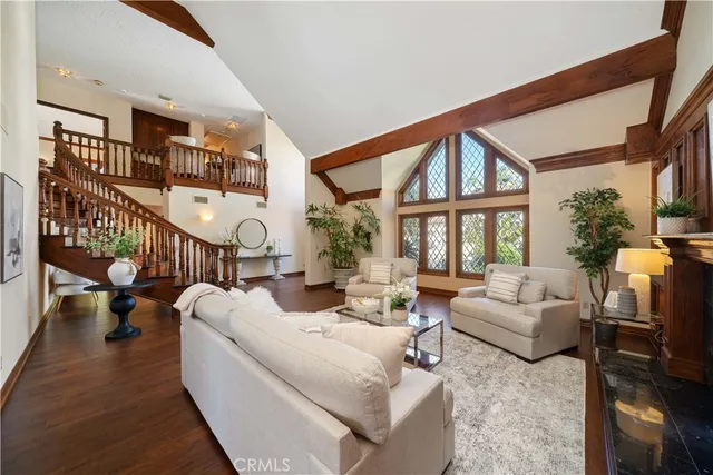 a living room with furniture fireplace and a large window