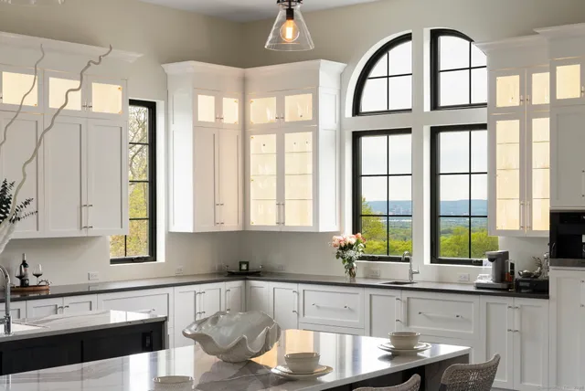 a kitchen with a stove a sink and a window