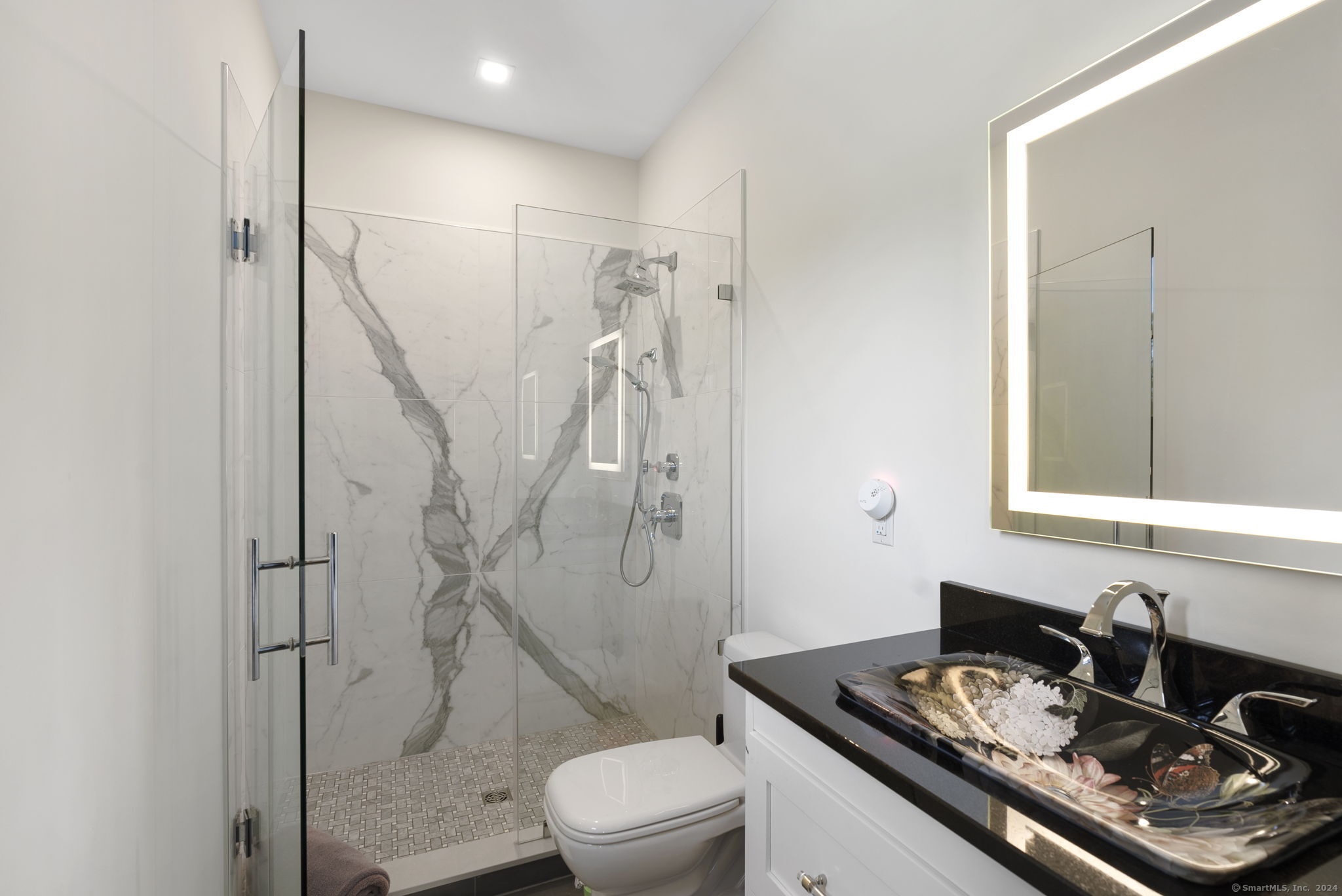 509 Cedar Ridge Drive Glastonbury, CT 06033 - Photo 39 of 40 a bathroom with a granite countertop sink a toilet and shower