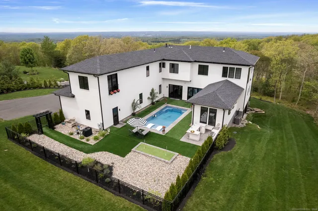 a front view of a house with a yard table and chairs