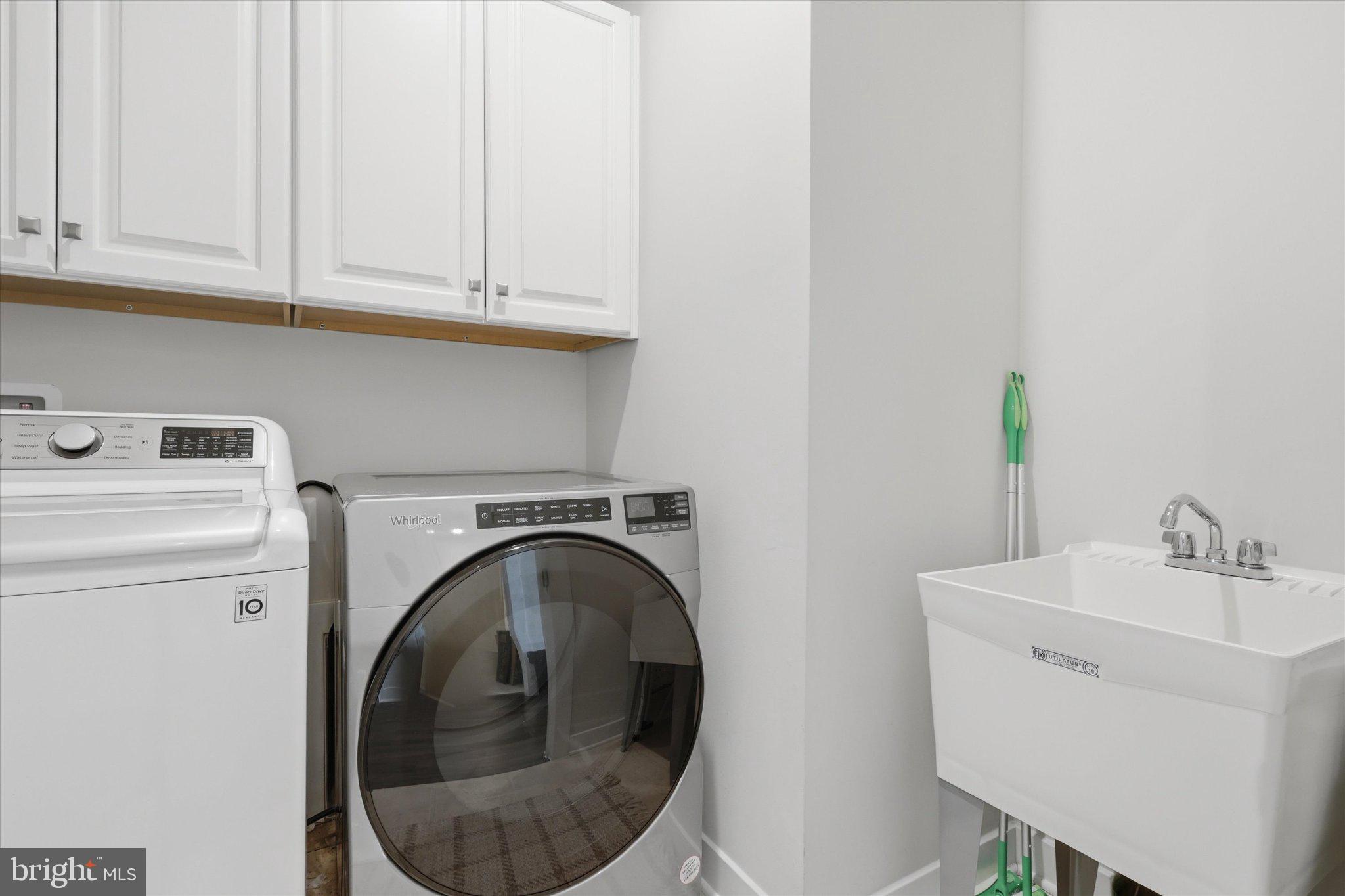 21839 Clarksburg Road Clarksburg, MD 20841 - Photo 18 of 39 Modern laundry space with sleek appliances.