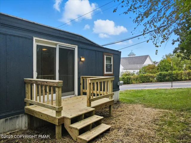 a view of a bench in back of a house
