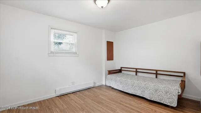 a view of room with hardwood floor and window