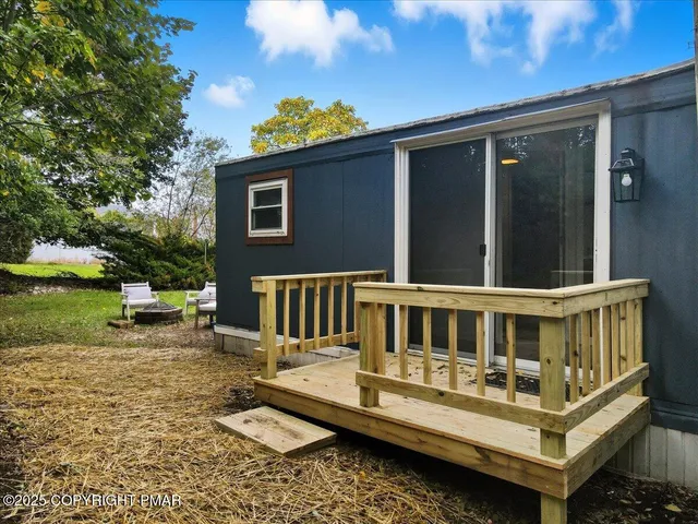 a view of a house with backyard porch and sitting area