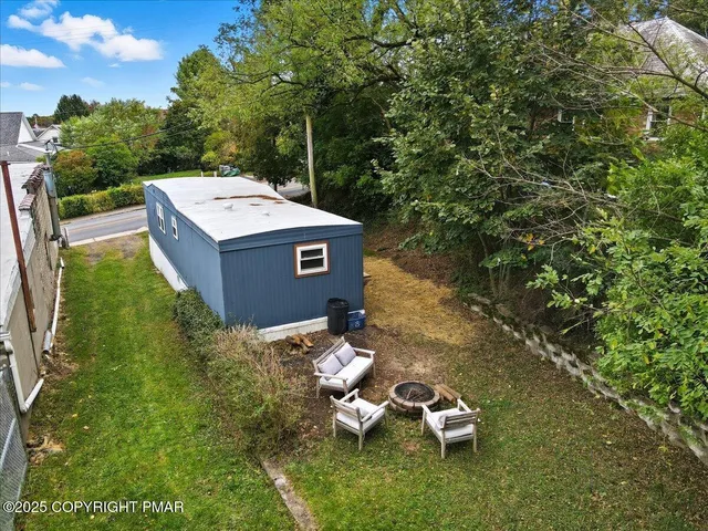 a backyard of a house with table and chairs