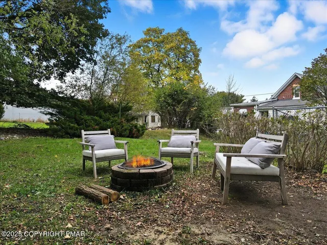 a view of a backyard with sitting area and garden