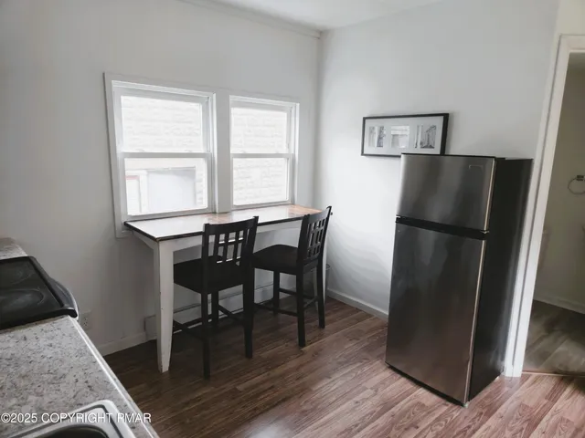 a kitchen with a table and refrigerator