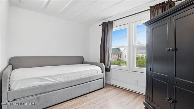 a bed sitting in a bedroom next to a window