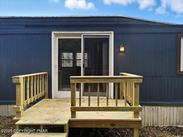 a view of a house with wooden fence