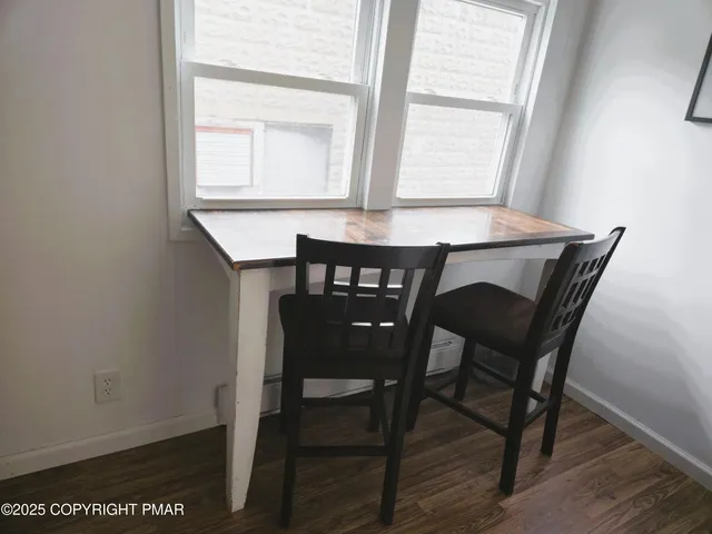 a view of a dining room with furniture and window