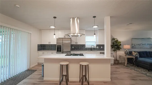 a kitchen with kitchen island granite countertop a sink and counter space