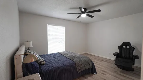 a bedroom with a bed and a painting on the wall