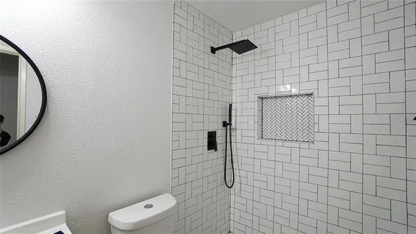 a bathroom with a toilet and a shower